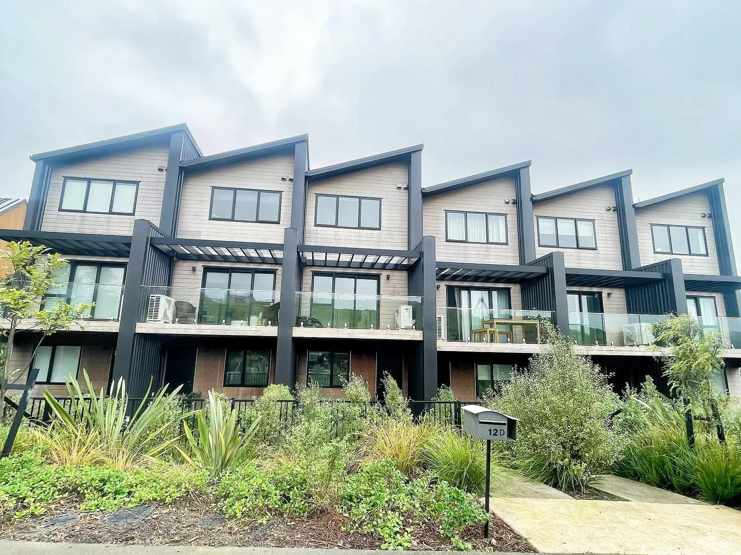 Completed townhouse exteriors with landscaped front gardens