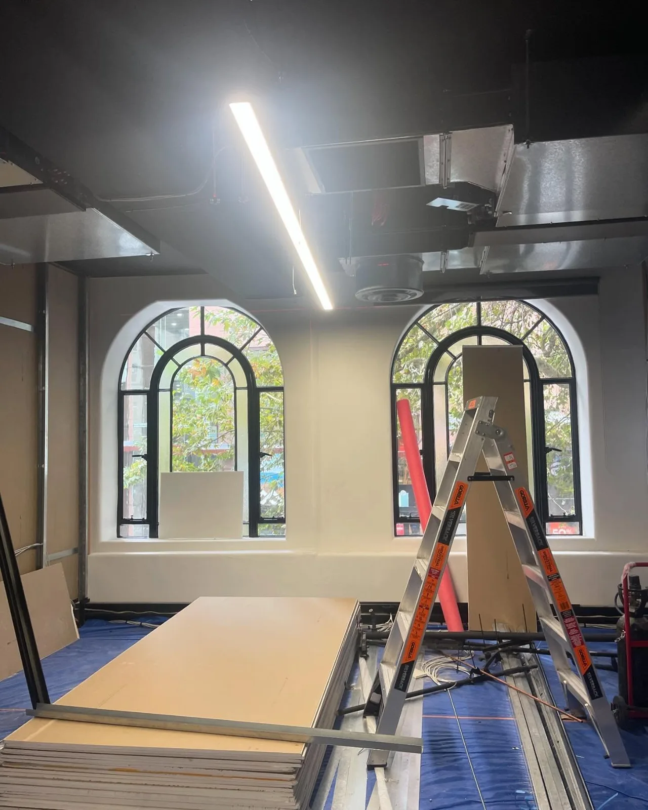 Interior painting work beneath a high ceiling